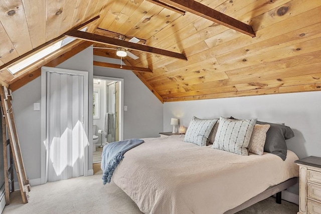 bedroom with connected bathroom, wooden ceiling, vaulted ceiling with skylight, and light carpet