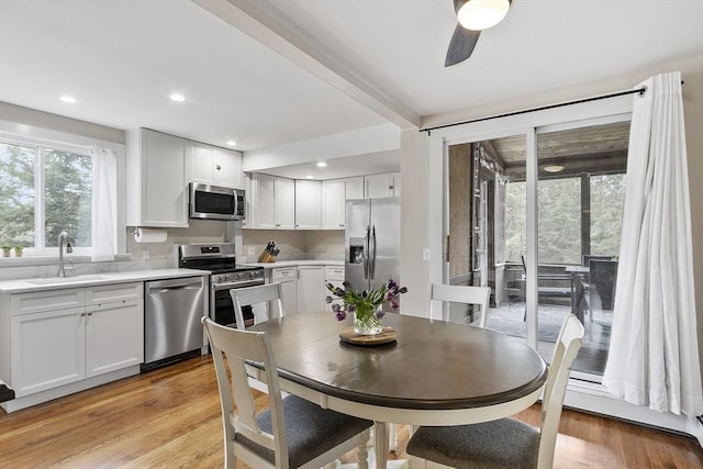 dining area with light wood-style floors, a ceiling fan, and recessed lighting