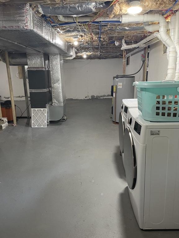 11 Pleasant St, Freetown, MA 02702 - unfinished basement featuring water heater, independent washer and dryer, and heating unit