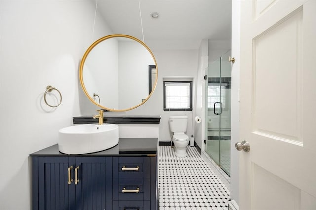 bathroom featuring walk in shower, vanity, and toilet