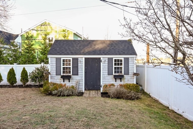 view of outbuilding with a yard