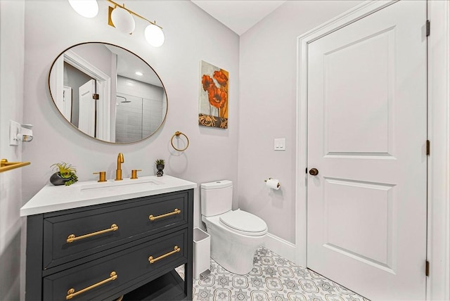 bathroom featuring vanity, toilet, baseboards, and tile patterned floors