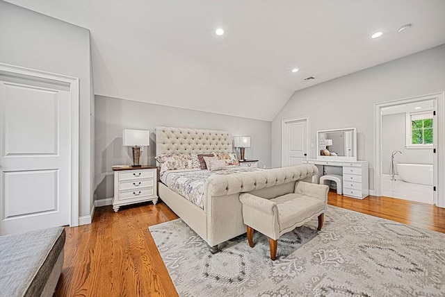 bedroom featuring vaulted ceiling, recessed lighting, and wood finished floors