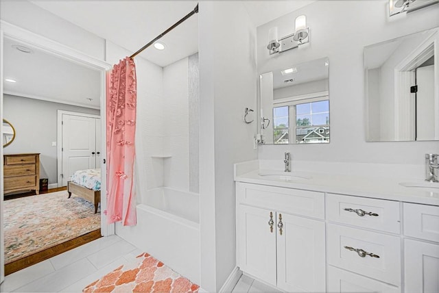 ensuite bathroom featuring a sink, tile patterned flooring, double vanity, and shower / bath combo with shower curtain