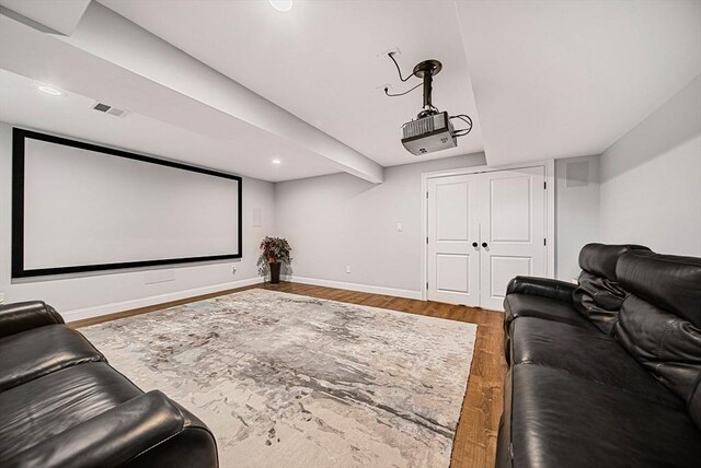 cinema featuring visible vents, wood finished floors, baseboards, and recessed lighting