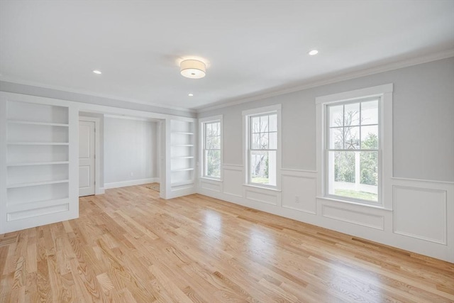 interior space with crown molding, built in features, and light wood-style floors