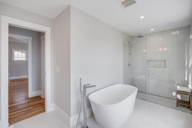 bathroom featuring a marble finish shower, recessed lighting, baseboards, visible vents, and a soaking tub