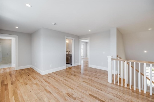 unfurnished room featuring recessed lighting, baseboards, and light wood finished floors