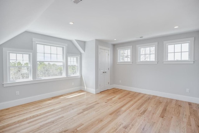 interior space featuring baseboards, recessed lighting, wood finished floors, and a healthy amount of sunlight