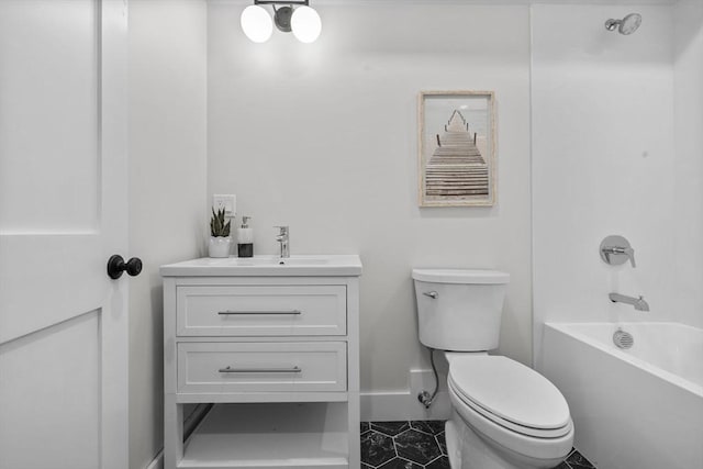 full bath with toilet, vanity, baseboards, and washtub / shower combination