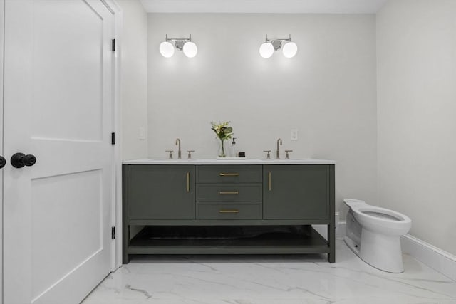 full bath with a sink, baseboards, toilet, and marble finish floor