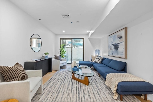 living area featuring visible vents and recessed lighting