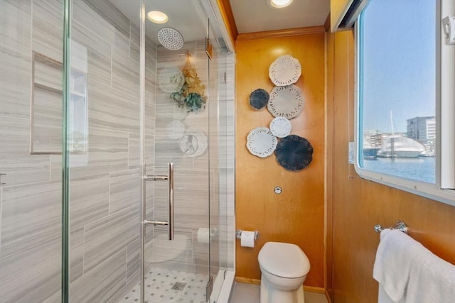 full bath with crown molding, toilet, and a stall shower