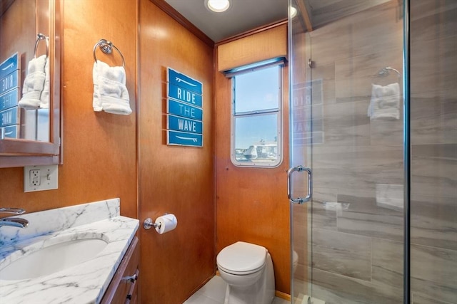 full bath with vanity, toilet, and a stall shower