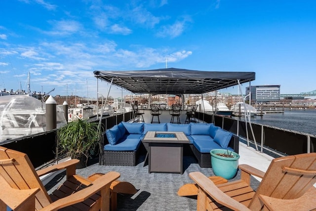 view of patio / terrace with an outdoor living space with a fire pit and a water view