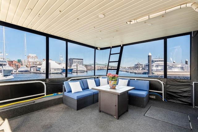 sunroom featuring wooden ceiling and a water view