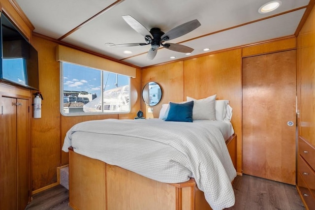 bedroom featuring wood finished floors, recessed lighting, wooden walls, crown molding, and ceiling fan