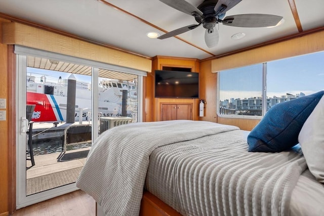 bedroom featuring access to exterior, wood finished floors, and ceiling fan