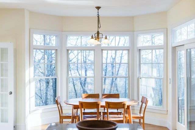 dining room featuring baseboards and a chandelier