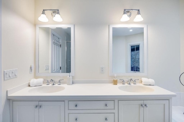 full bath featuring double vanity and a sink