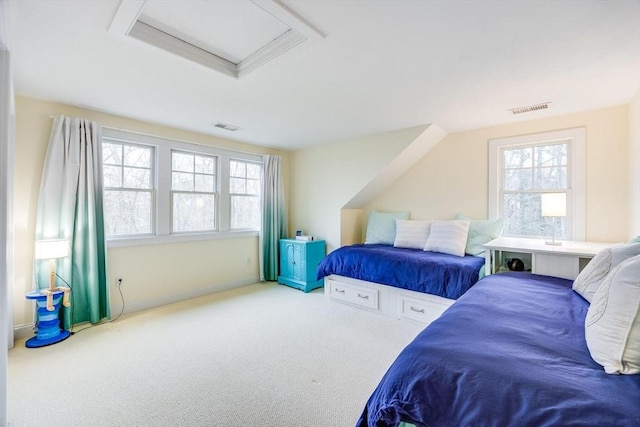 bedroom with attic access, visible vents, carpet floors, and multiple windows