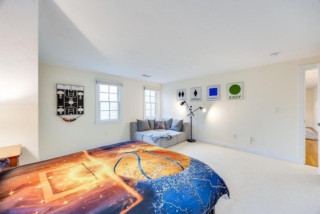 carpeted bedroom featuring visible vents and baseboards