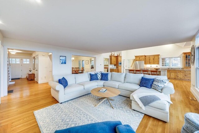 living area with light wood finished floors and a wealth of natural light