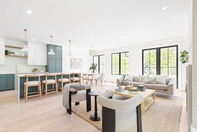 living room with recessed lighting and light wood-style flooring