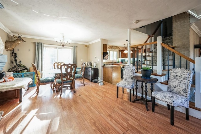 375 Winchendon Rd, Ashburnham, MA 01430 - dining space featuring a chandelier, light wood finished floors, a textured ceiling, stairway, and ornamental molding