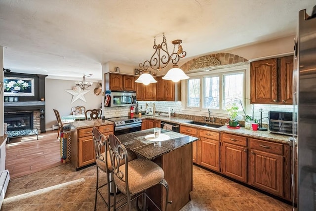 375 Winchendon Rd, Ashburnham, MA 01430 - kitchen with stainless steel appliances, brown cabinets, and backsplash
