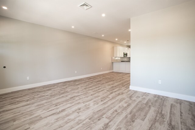 unfurnished living room featuring light wood-type flooring