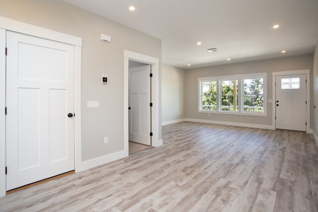 foyer entrance with light wood-type flooring