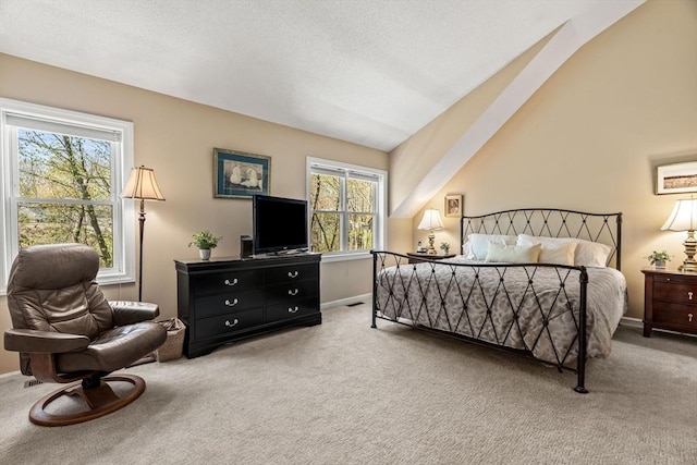 carpeted bedroom featuring baseboards, multiple windows, and lofted ceiling