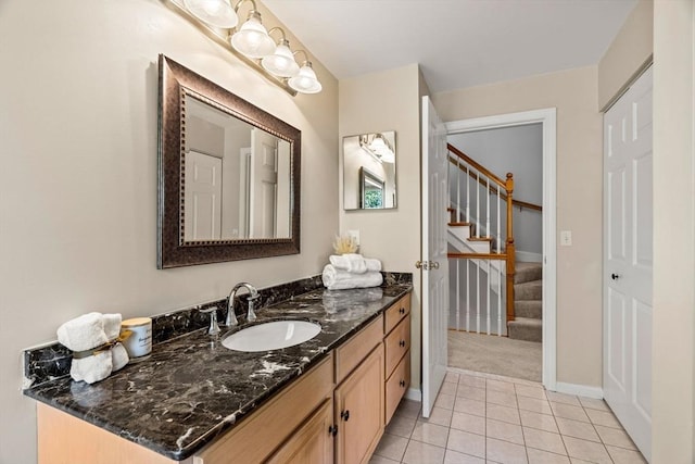 bathroom with tile patterned floors, baseboards, and vanity