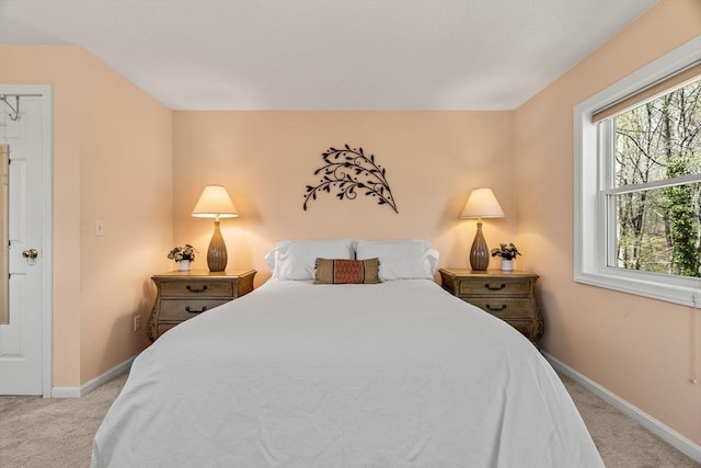 carpeted bedroom featuring baseboards