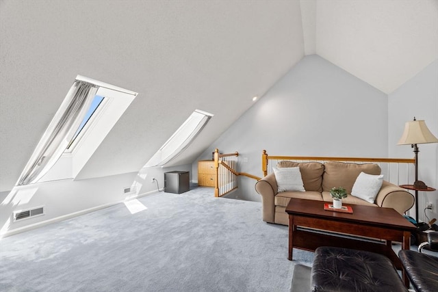 carpeted living area featuring visible vents and lofted ceiling with skylight