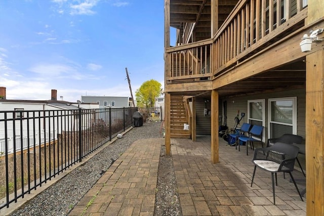 view of patio with a deck and a fenced backyard