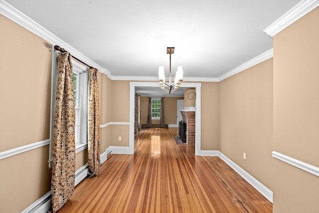 5 Liberty Rd, Hingham, MA 02043 - unfurnished dining area with wood-type flooring, a chandelier, ornamental molding, and a baseboard radiator