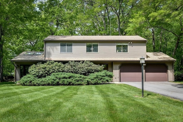 38 Stagecoach Dr, Ashland, MA 01721 - view of front facade with driveway, a front yard, and view of scattered trees