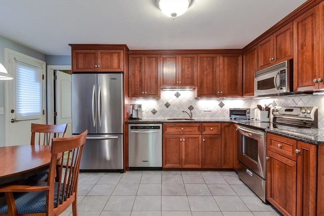 38 Stagecoach Dr, Ashland, MA 01721 - kitchen featuring stainless steel appliances, tasteful backsplash, dark stone countertops, and a sink