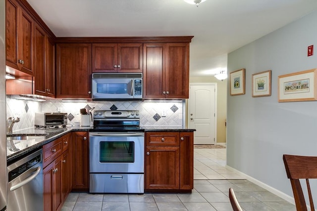 38 Stagecoach Dr, Ashland, MA 01721 - kitchen with appliances with stainless steel finishes, a sink, backsplash, light tile patterned flooring, and dark stone counters