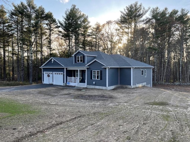 view of front of house with a porch and a garage