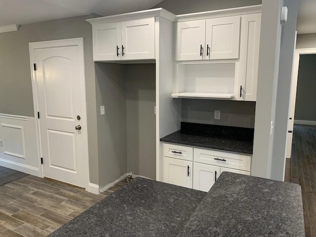 kitchen with dark hardwood / wood-style floors and white cabinets