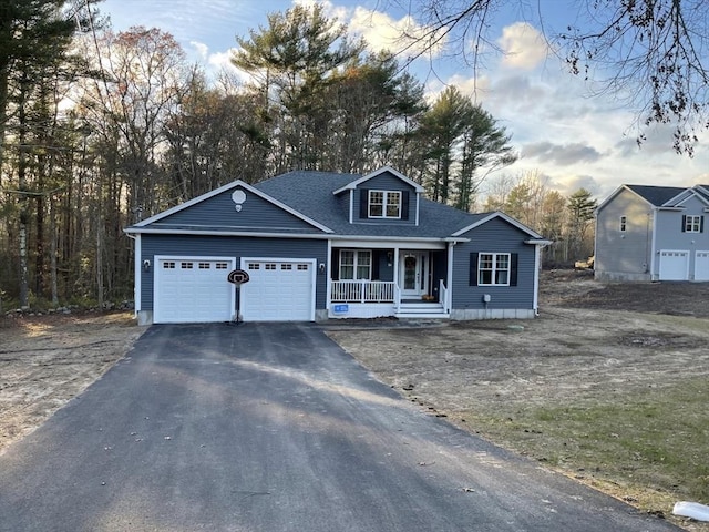 view of front facade with a garage and covered porch