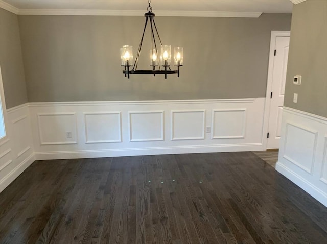 unfurnished dining area with dark hardwood / wood-style flooring, a notable chandelier, and ornamental molding