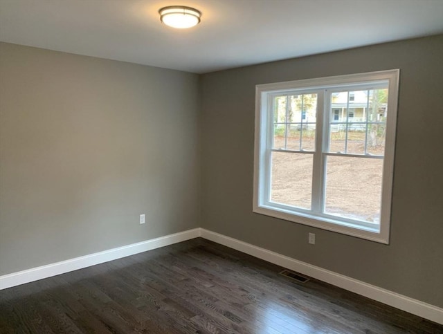 spare room featuring dark hardwood / wood-style floors