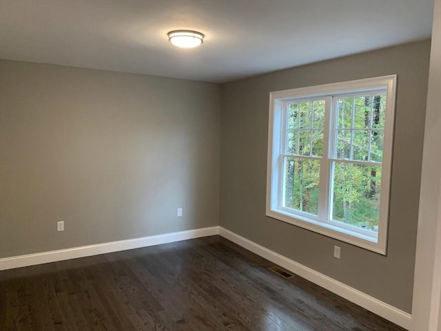 empty room with dark hardwood / wood-style floors