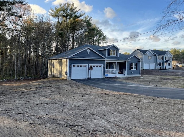 view of front facade with a garage and covered porch