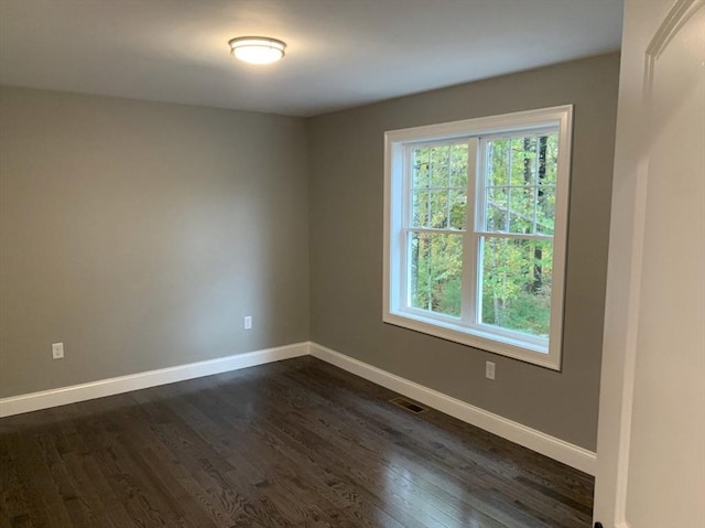 unfurnished room featuring dark hardwood / wood-style flooring