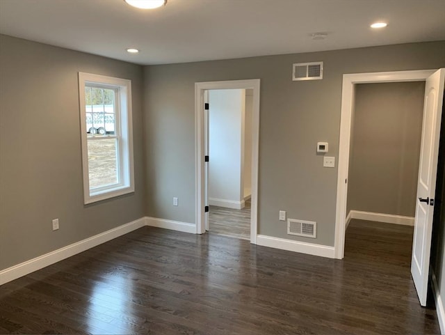 spare room with dark hardwood / wood-style flooring